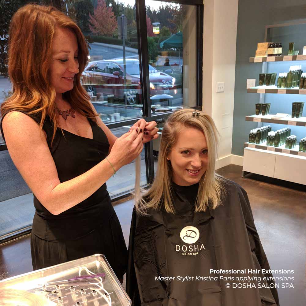 Master Stylist Kristina Paris applying hair extensions at Dosha Salon Spa.