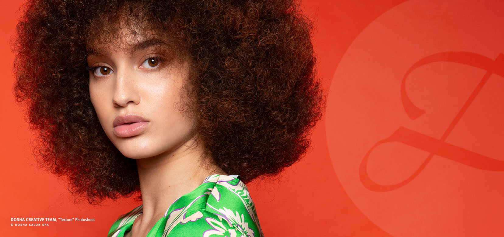 image of the dosha creative team "texture" photoshoot featuring a young woman with her hair with lots of texture on a red background