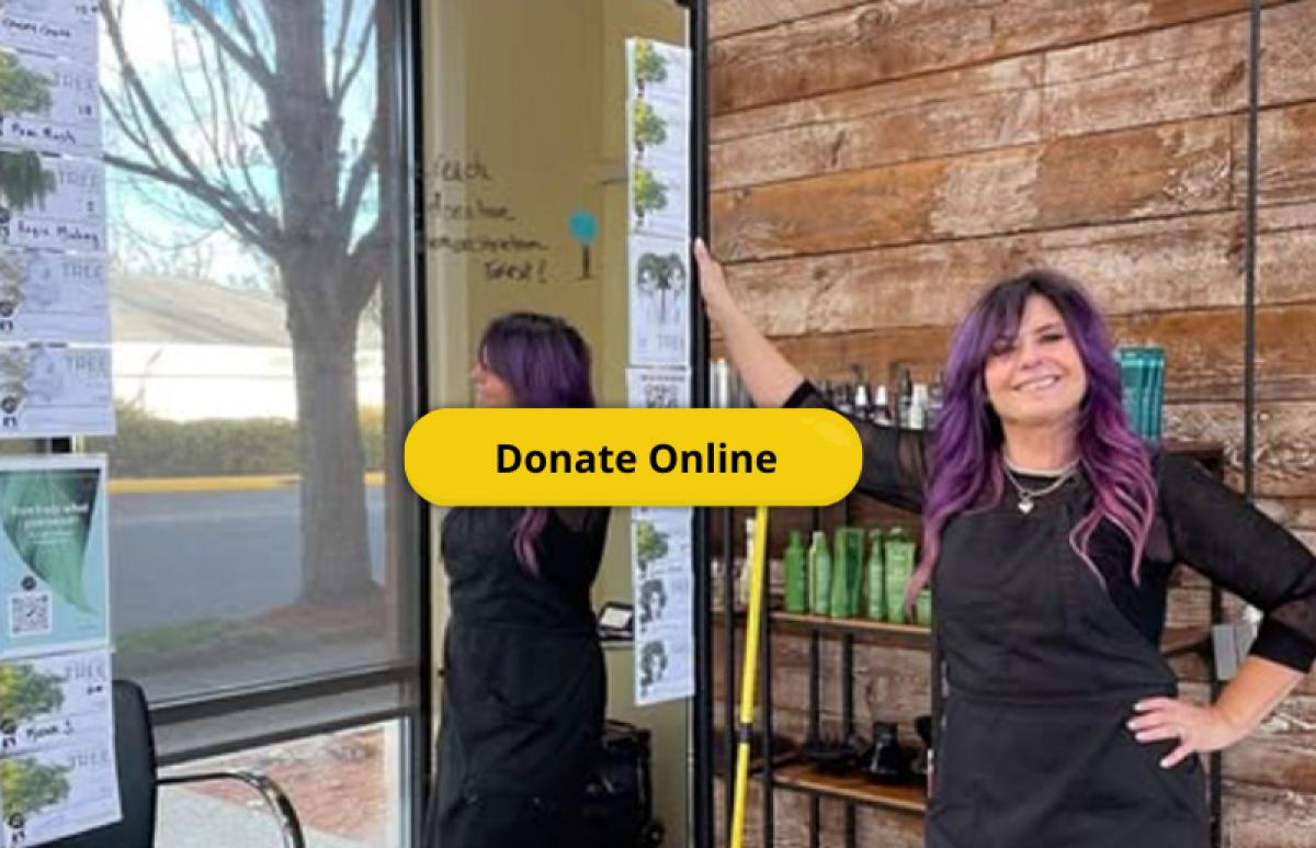 image of master stylist kari rivera with donation cards on her mirror in-salon
