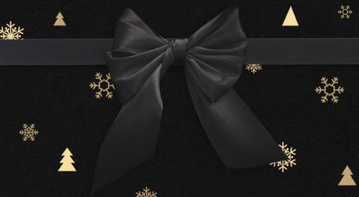 image of VIP invite with a black satin bow, golden snowflakes and a black background