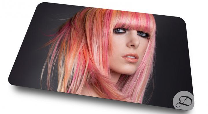 Image of a dosha creative team shoot of a young woman with dimensional fashion color hair in pink and peach. Image used on the gift card.