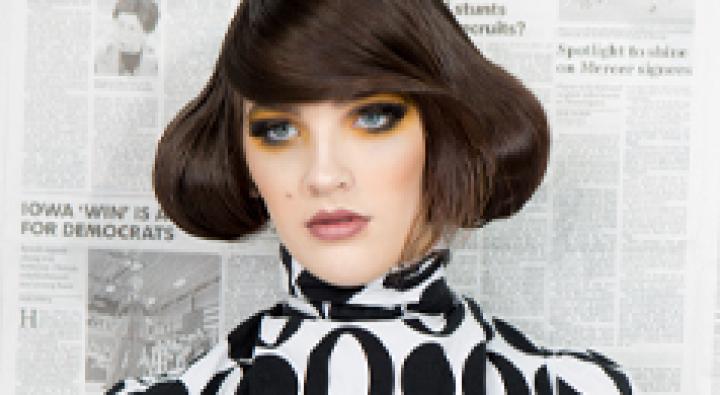 Image of Dosha Creative Team Photoshoot, Editrix, with a woman standing in front of a newspaper background