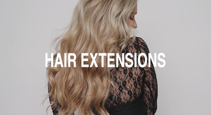 Real client with long, dimensional hair extensions styled in soft waves