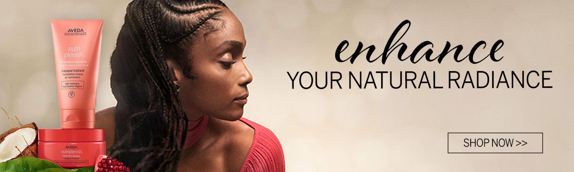 Image of a beautiful woman who uses Aveda products made with natural ingredients.