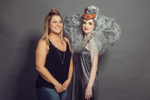 photoshoot of model posing with circus inspired elephant hair and makeup in grey dress and heels with stylist