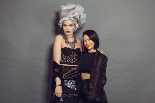 photoshoot of model posing in circus fortune teller inspired makeup and hairstyle in a dress with stylist who created the look