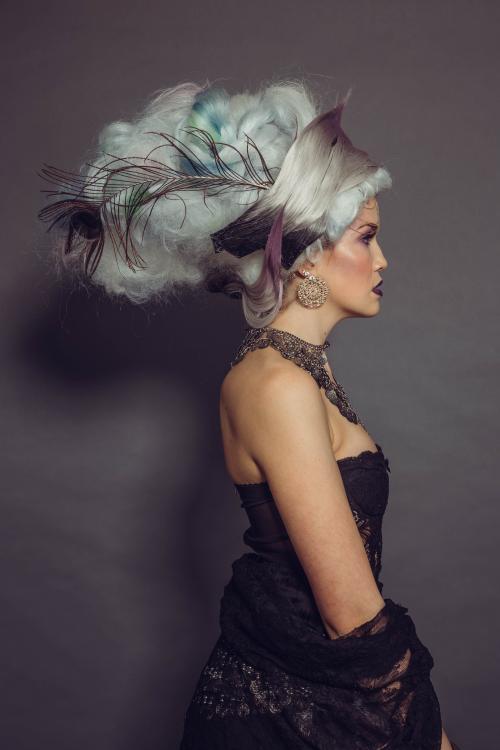 photoshoot of model in circus inspired fortune teller hairstyle and makeup in a dress with makeup and jewelry