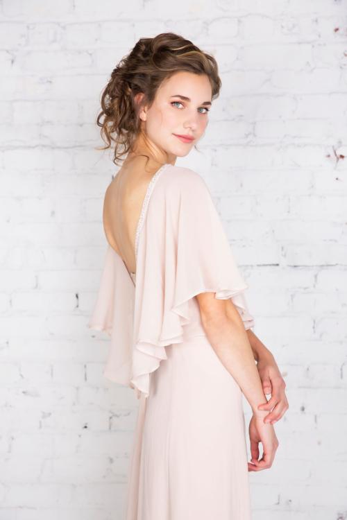 by the Bridal Elite Team Bridesmaid posing in bridal photoshoot wearing light pink dress with loose updo and makeup