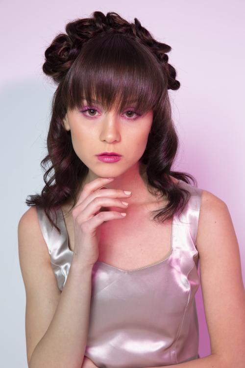 Photoshoot of model posing with flower hairstyle and pink makeup