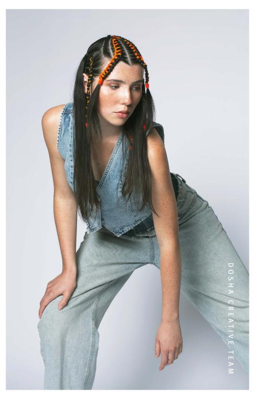 image of dosha creative team photoshooot with a young woman wearing fashionable denim vest and pants with her hair braids