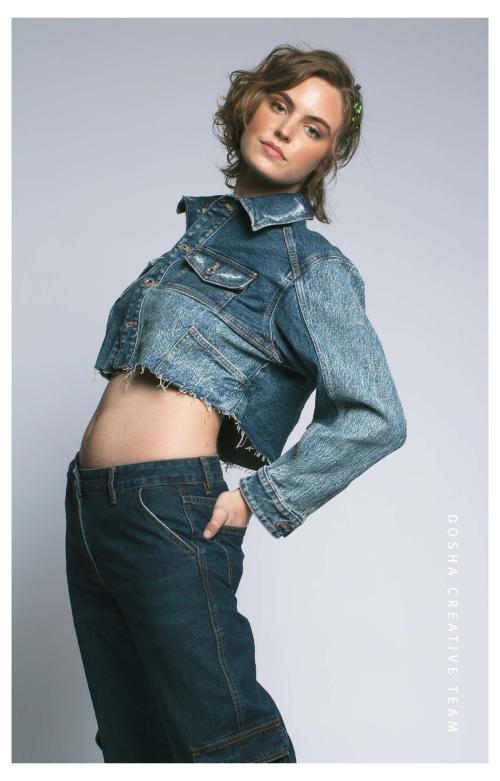 Braids x Denim photoshoot by dosha creative team with a young woman with blonde hair with a side braid wearing a cropped denim jacket and jeans